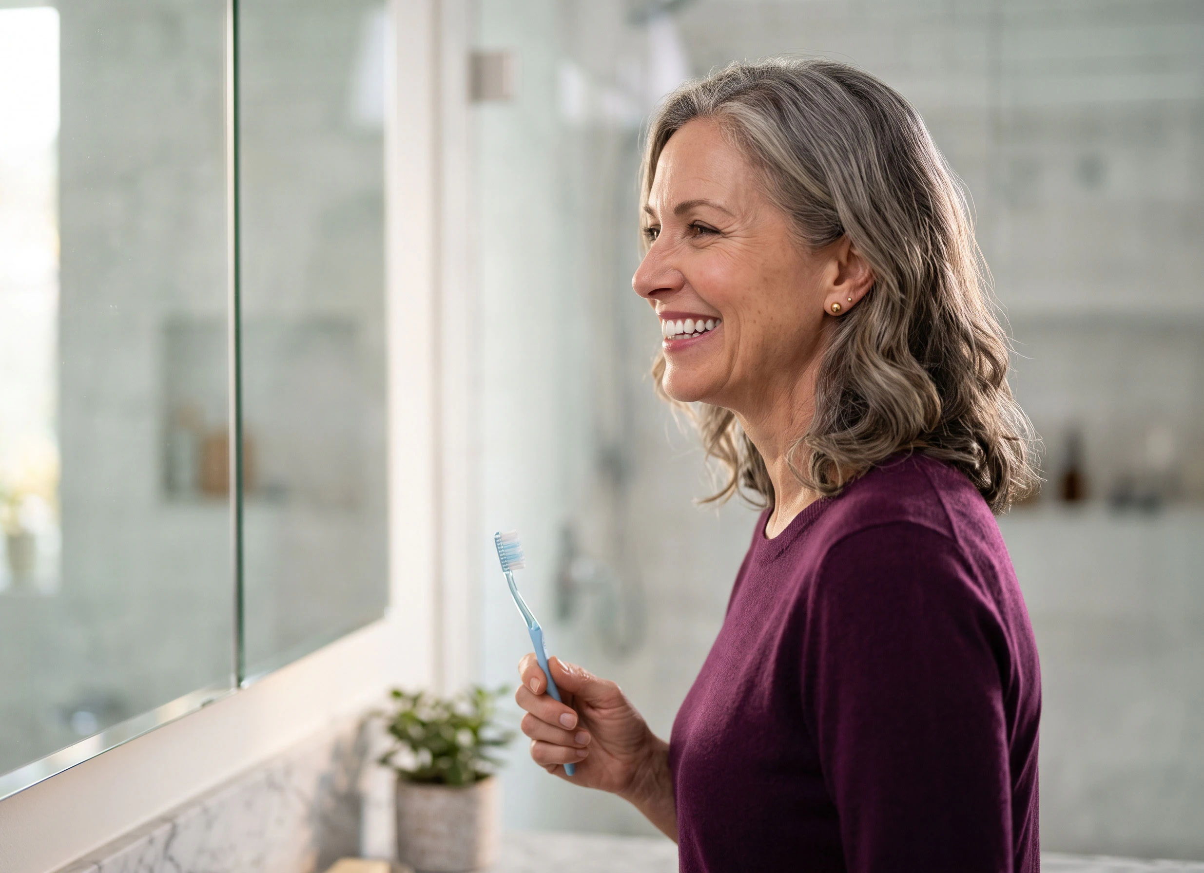 Woman smiling while holding a toothbrush