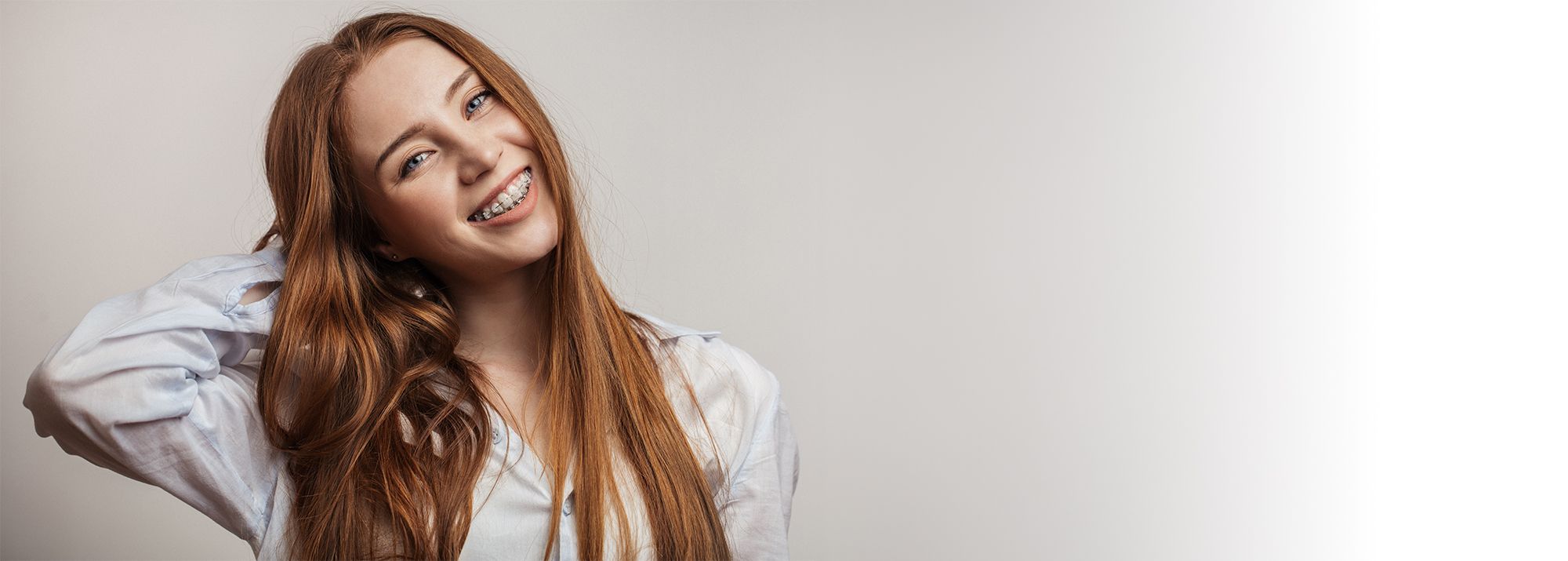 Young girl smiling with clear braces