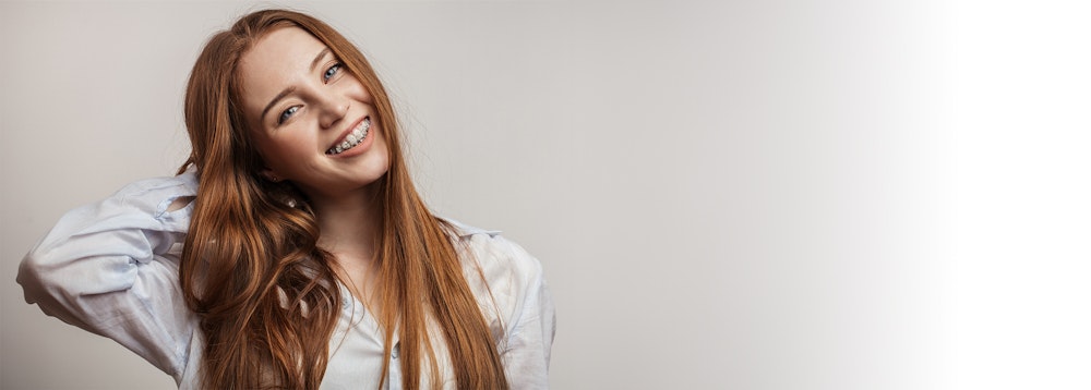 Young girl smiling with clear braces