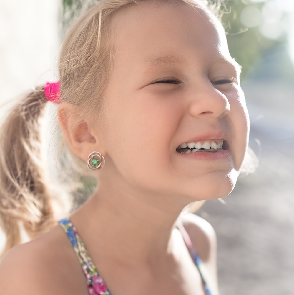 Young girl smiling with crooked teeth