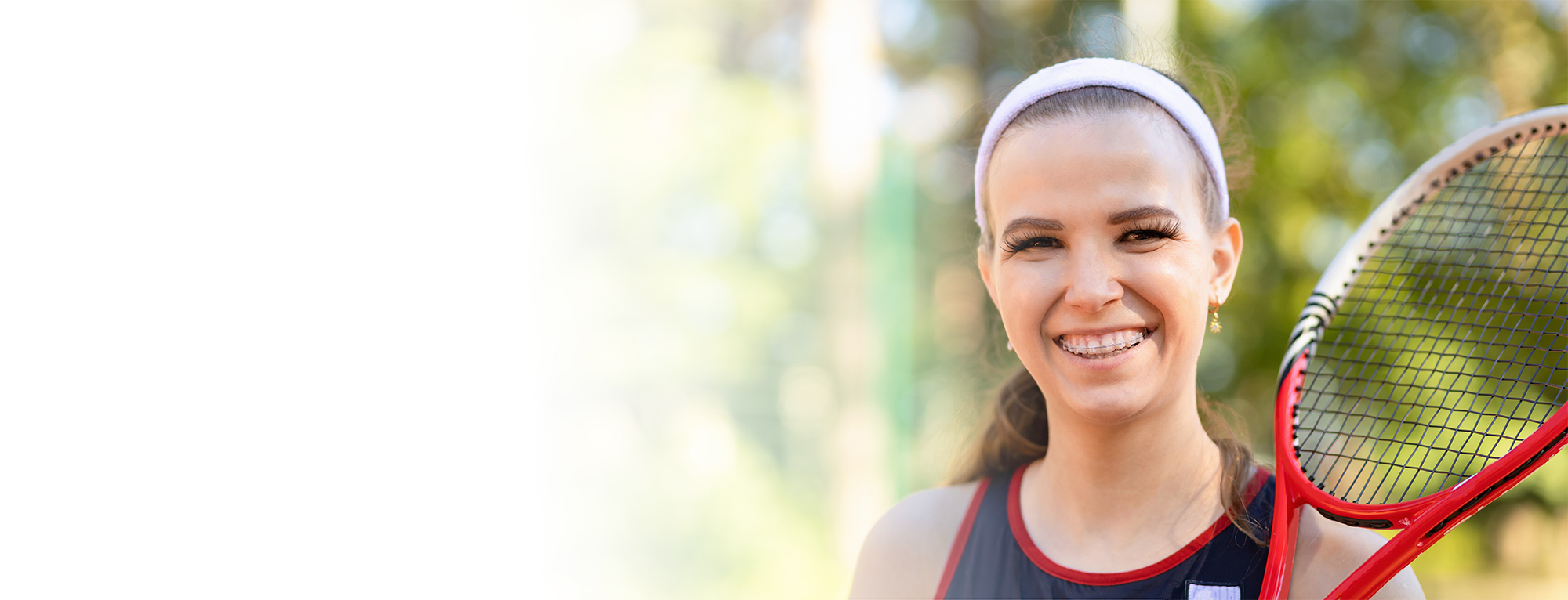 girl-with-clear-braces-holding-a-racquet
