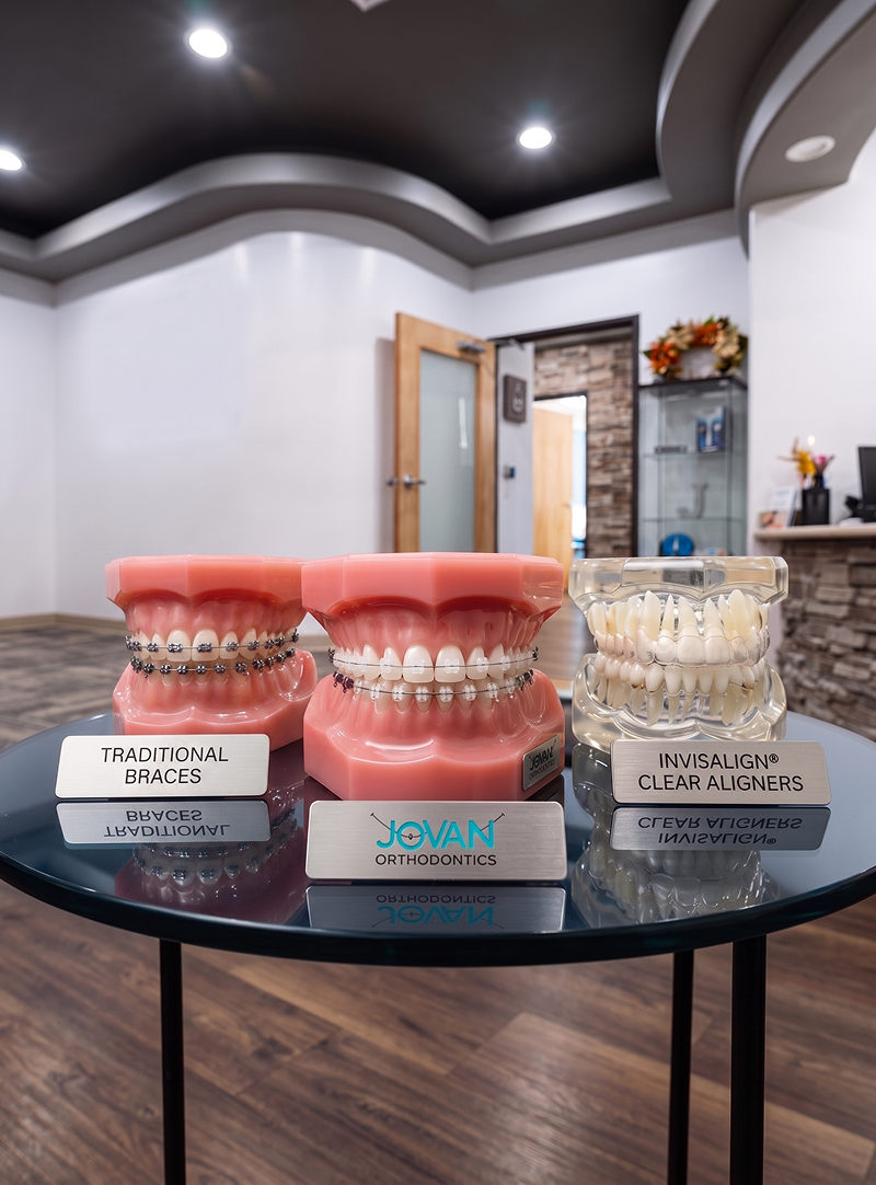 teeth models one with braces, one with ceramic braces, and one with invisalign