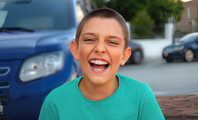 Young boy smiling with clear braces