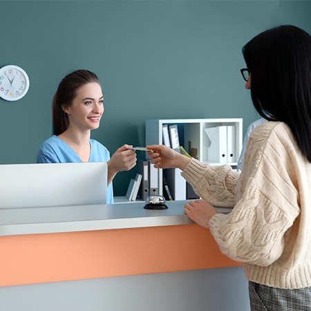 Woman paying for eye care with a credit card