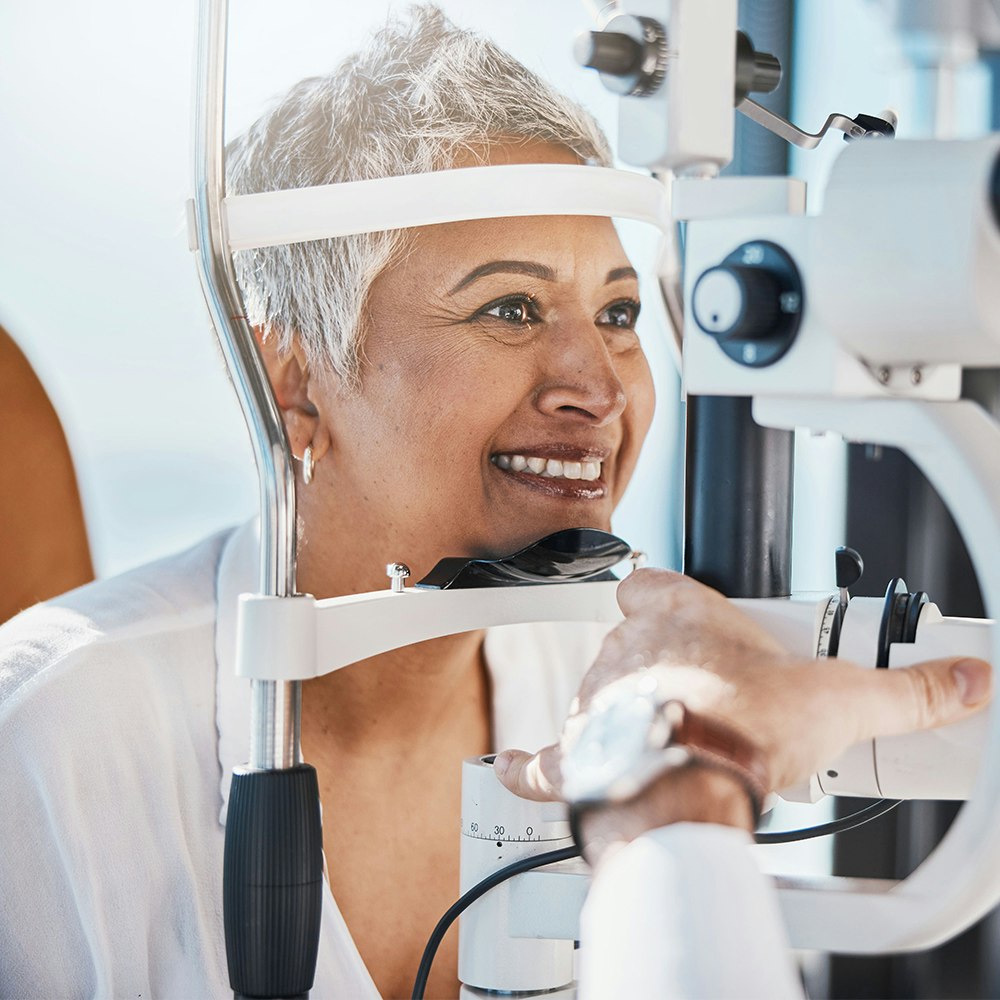 Smiling woman having her eyes examined