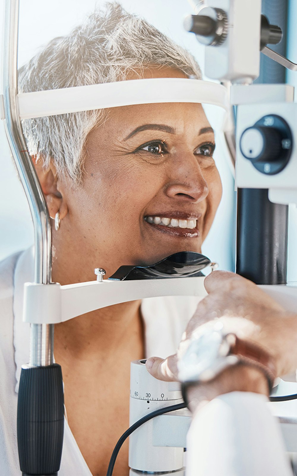 Smiling woman having her eyes examined