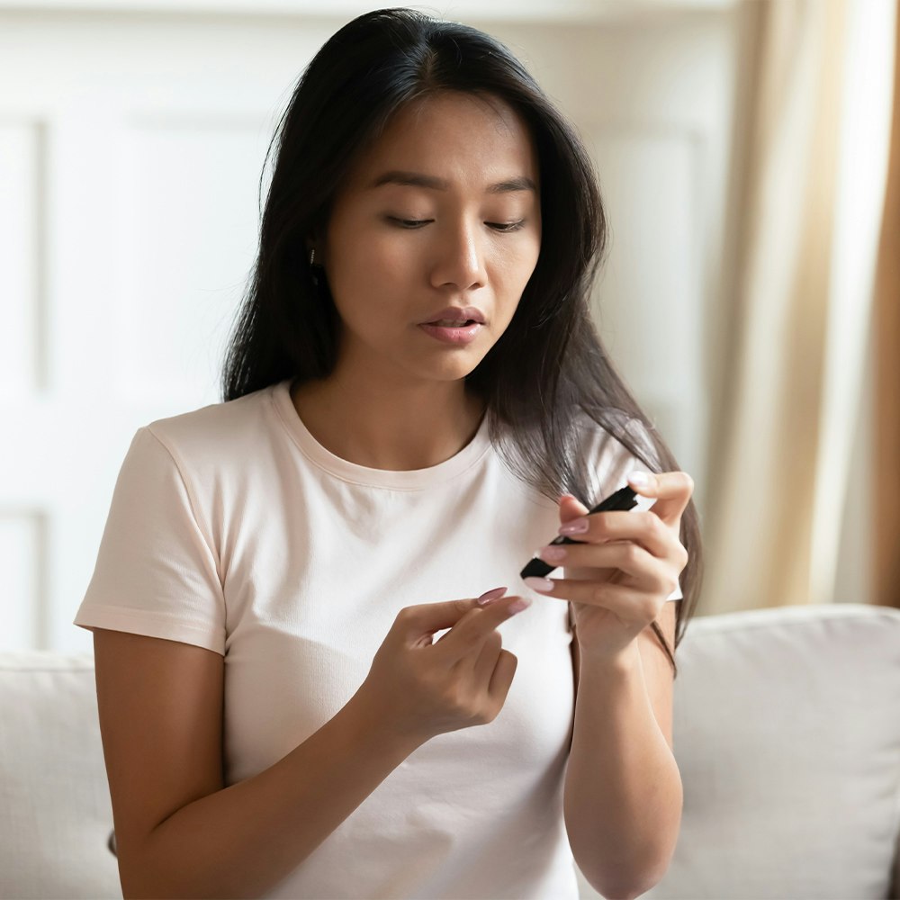 a woman checking her blood sugar