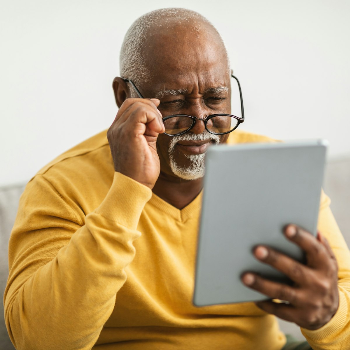 man squinting to read due to cataract