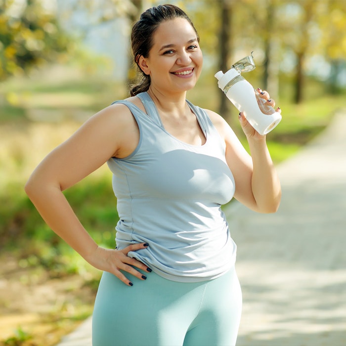 a woman exercising and drinking water