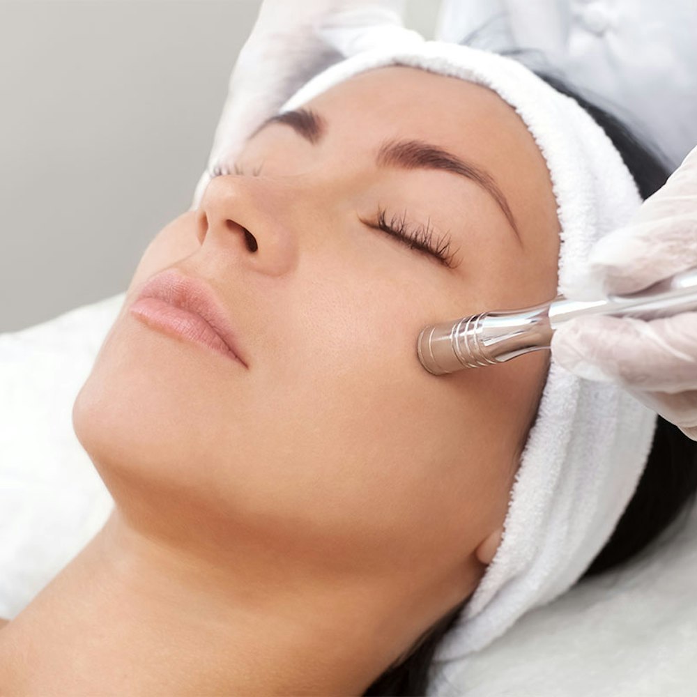 Woman undergoing microneedling
