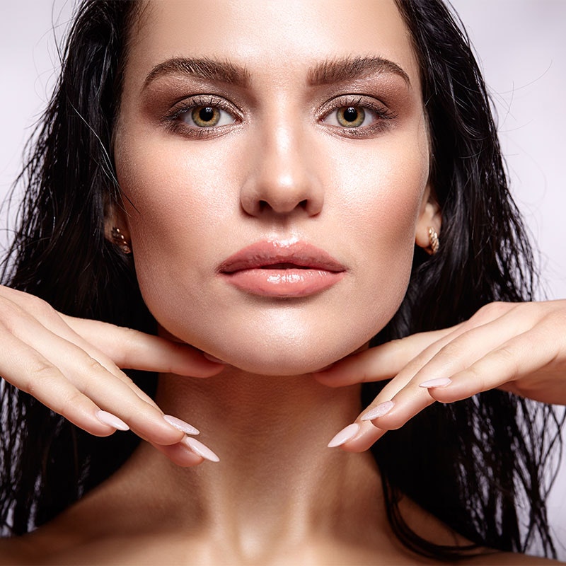 Close-up of woman's face with plump lips and cheeks
