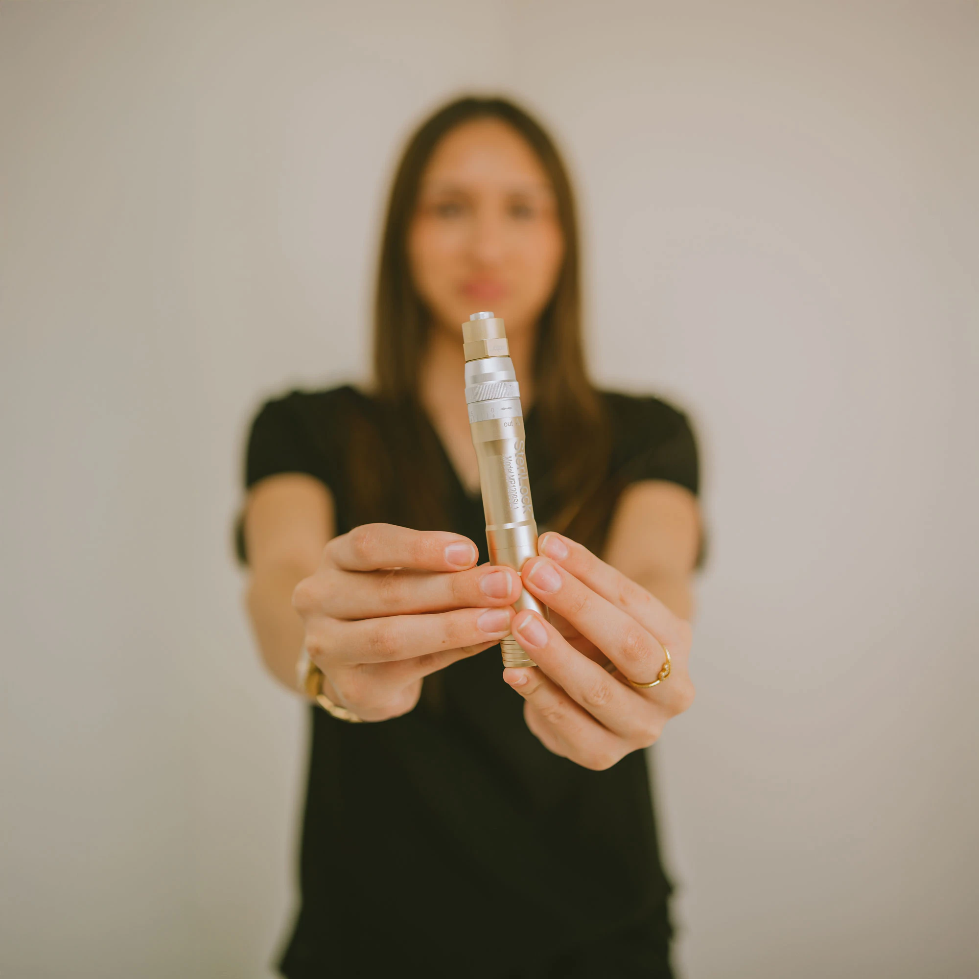 woman holding skincare device