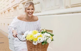 women on bike with flowers in the basket