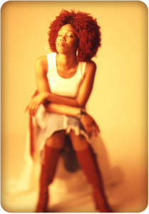 Woman with afro sitting in a chair looking peaceful