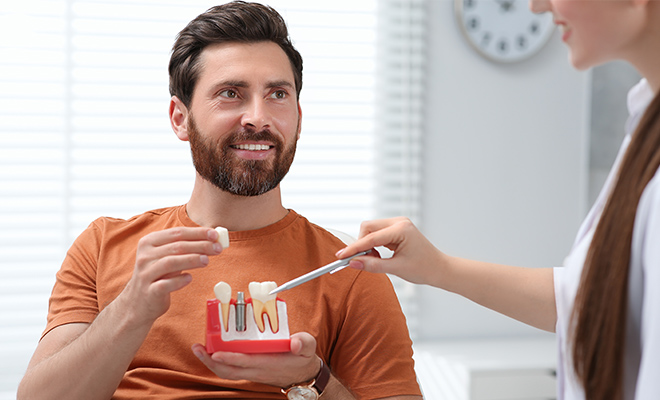 Man discussing dental crowns with his doctor