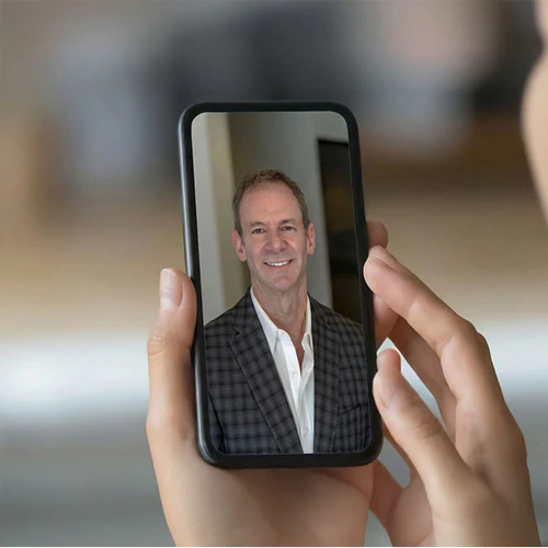 Dr. Wayne Myles on a smartphone call