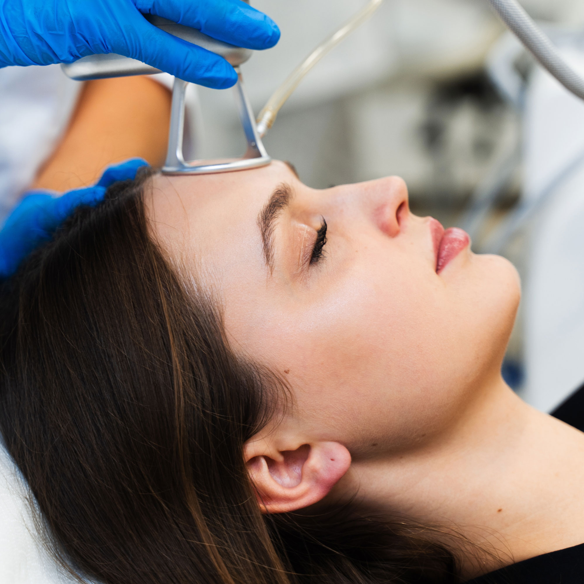 Woman undergoing laser skin treatment