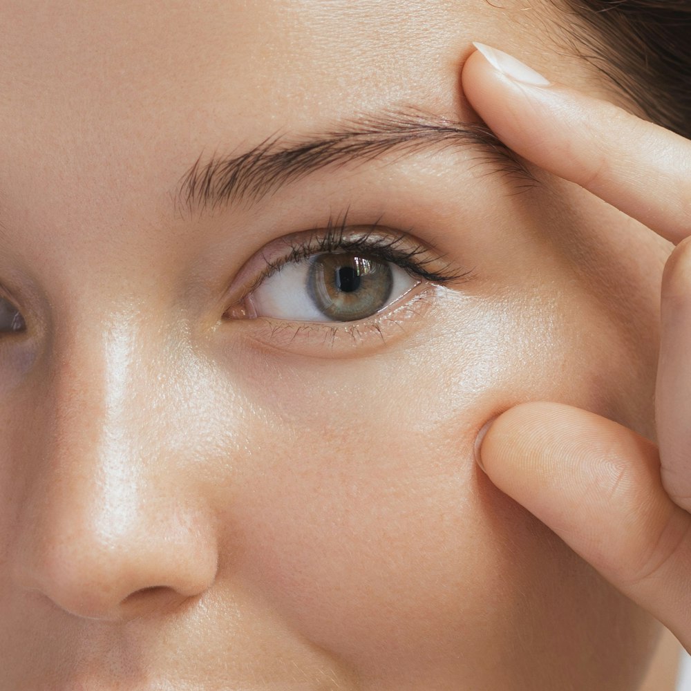 woman framing her eye with her fingers