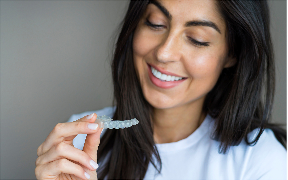 woman holding teeth whitening tray