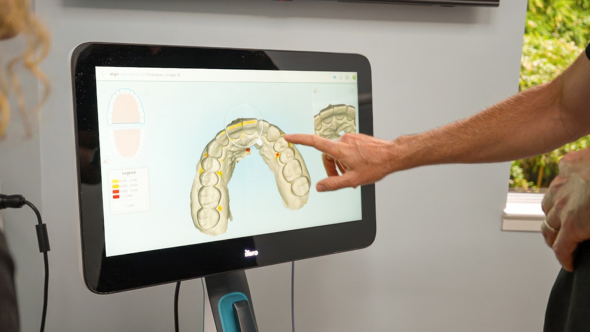 Dr. Catalano showing dental scans on screen