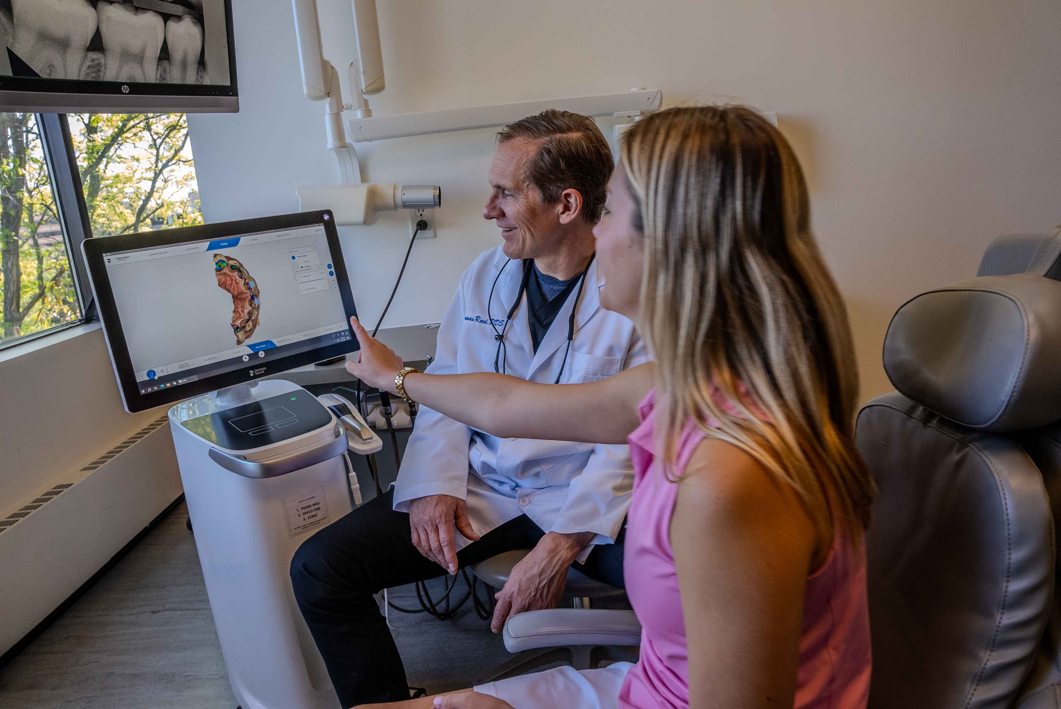 Dr. Reed reviewing scans with a patient