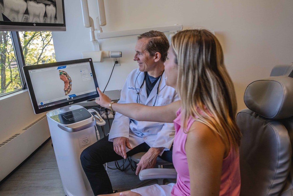 Dr. Reed reviewing scans with a patient