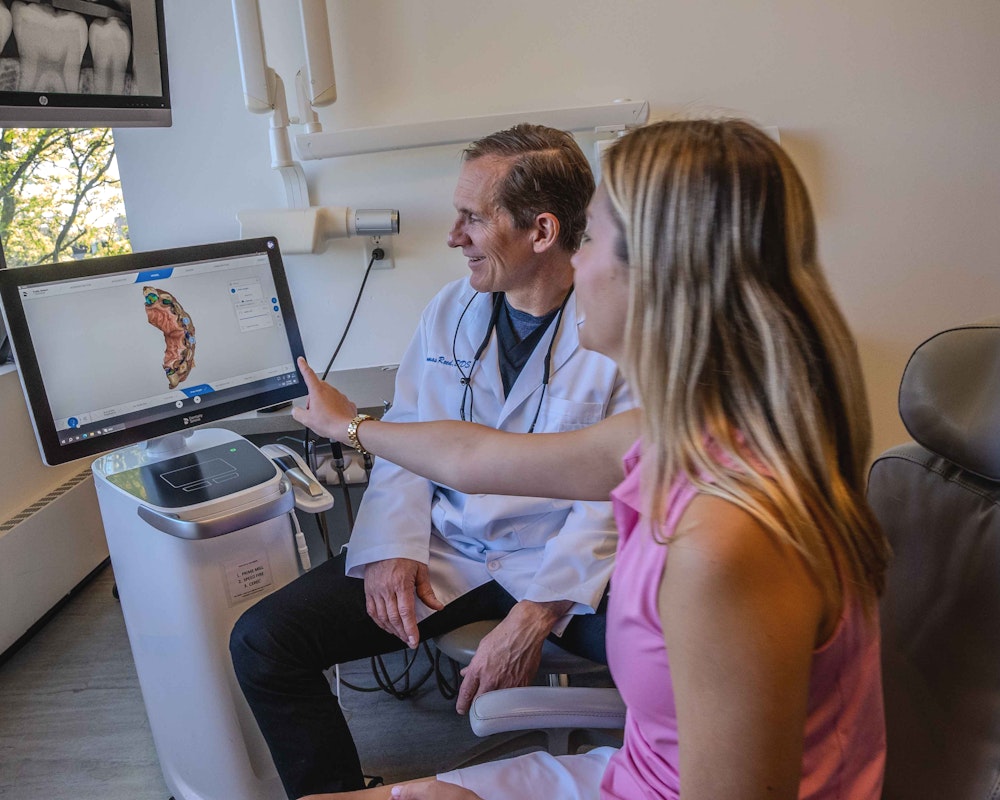 Dr. Reed reviewing scans with a patient