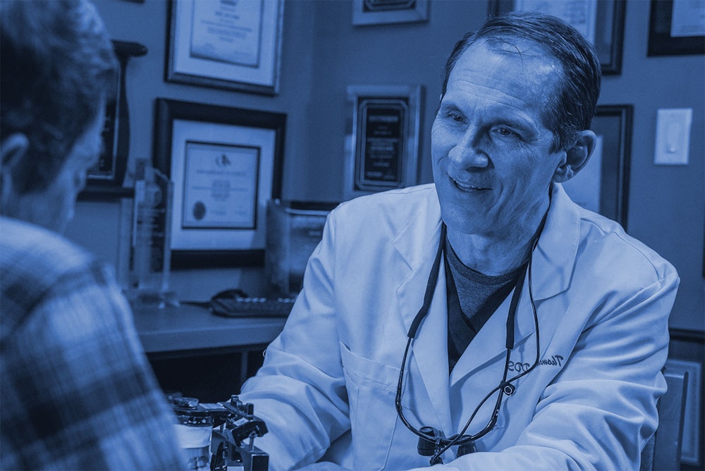 dr. thomas reed meets with a patient