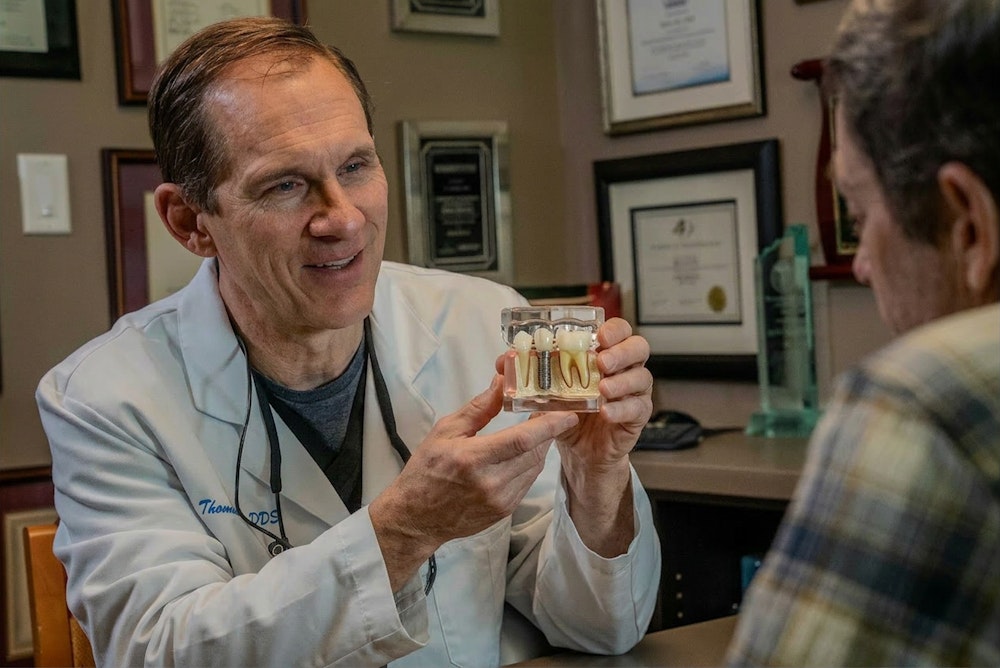 Dr. Reed showing dental model