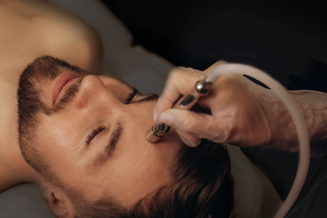 Man receiving microdermabrasion treatment