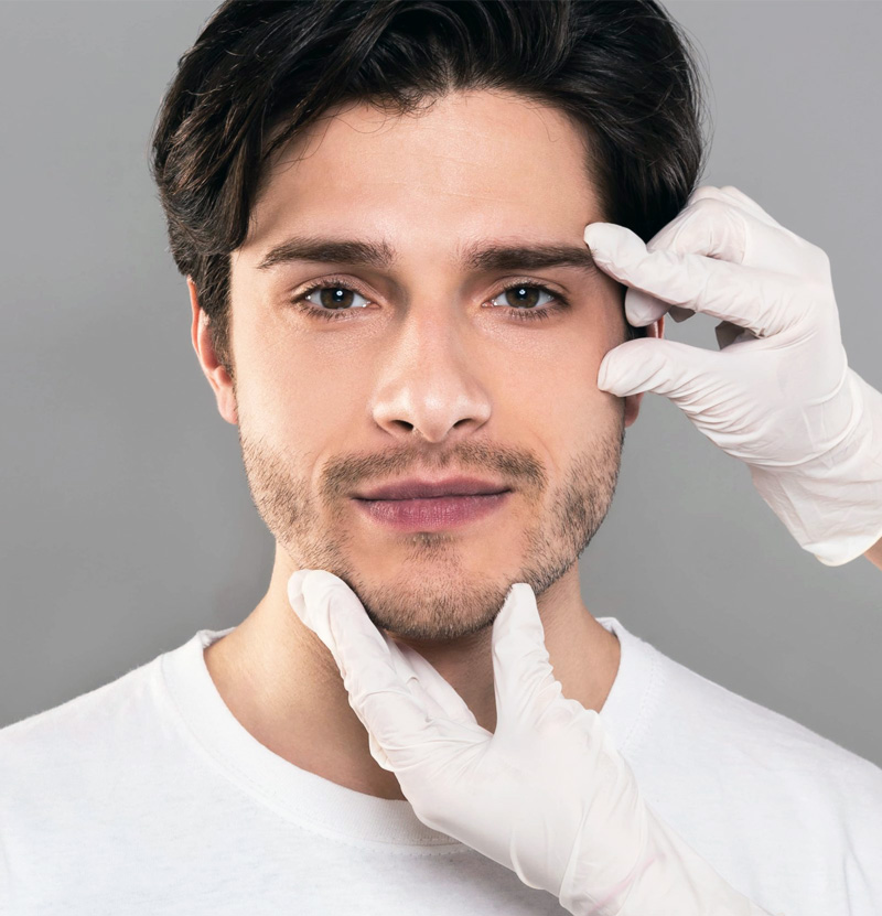 man with gloved hands touching face