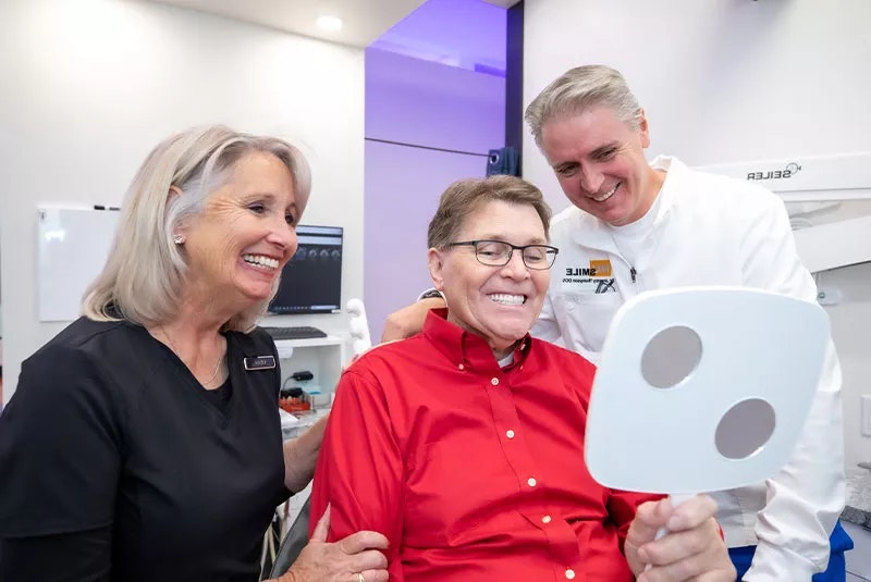 NuSmile Team and Patient smiling at their after results