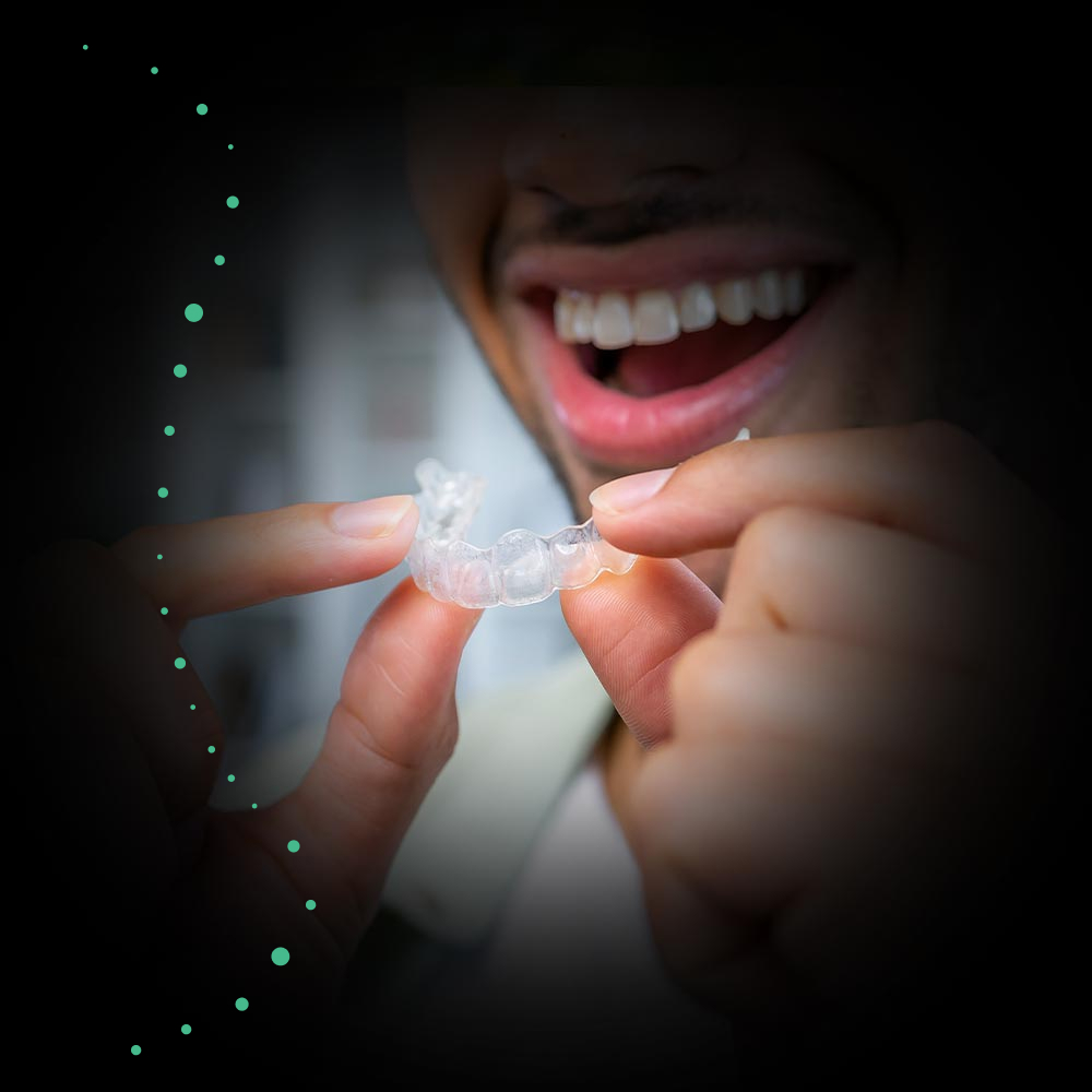 man holding invisalign tray