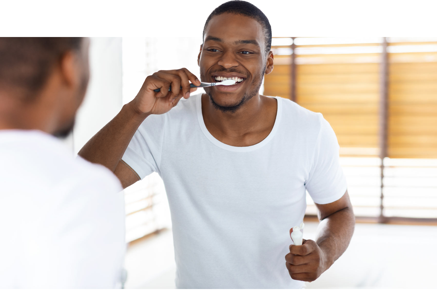 Austin man brushing his teeth in the mirror