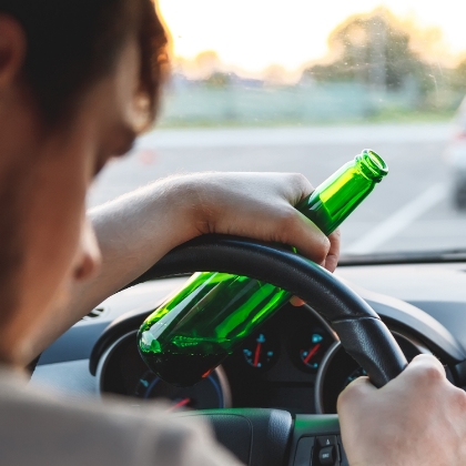 Tucson drunk driver holding beer bottle
