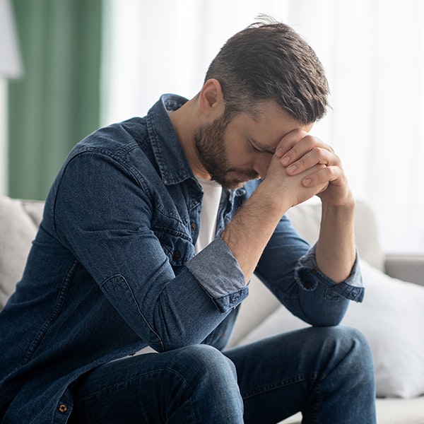 Man accused of assault with head in hands