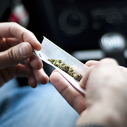 person rolling a joint