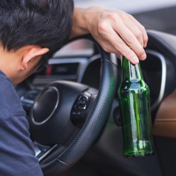 man drinking behind the wheel