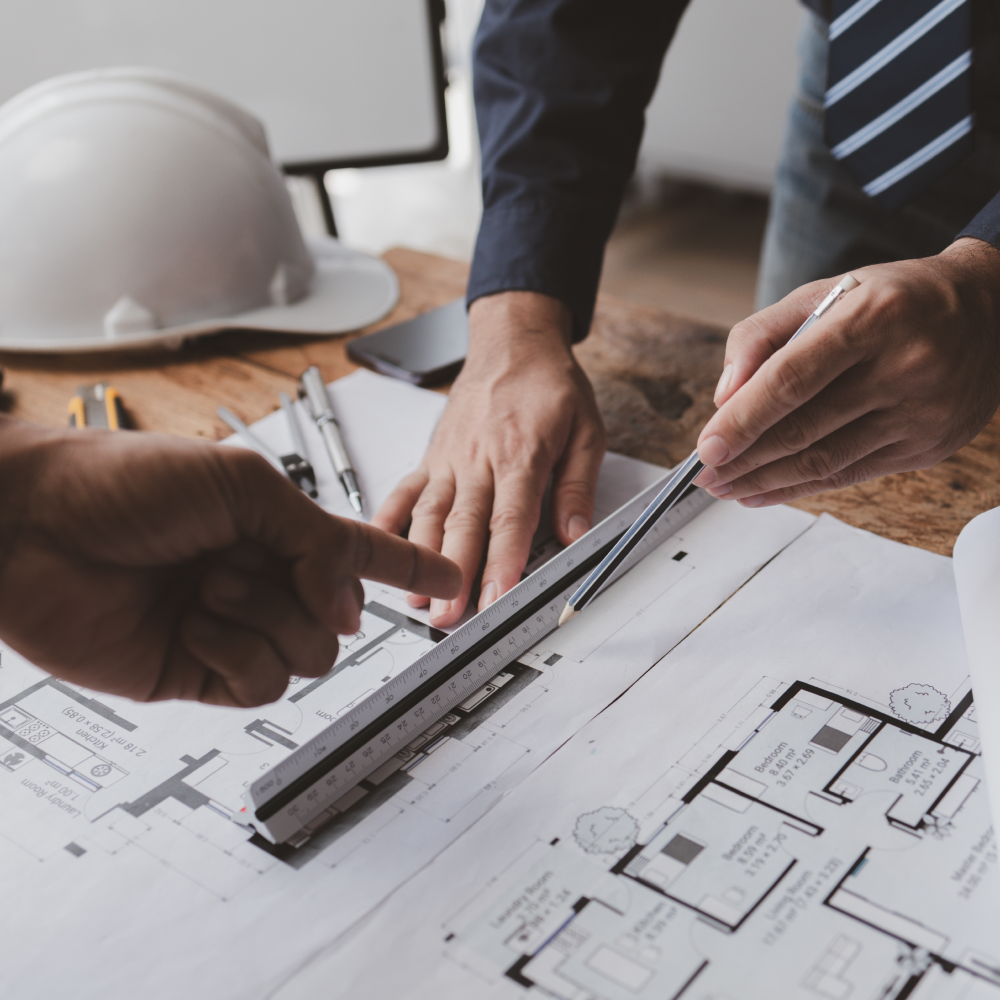 Builders pointing at plans