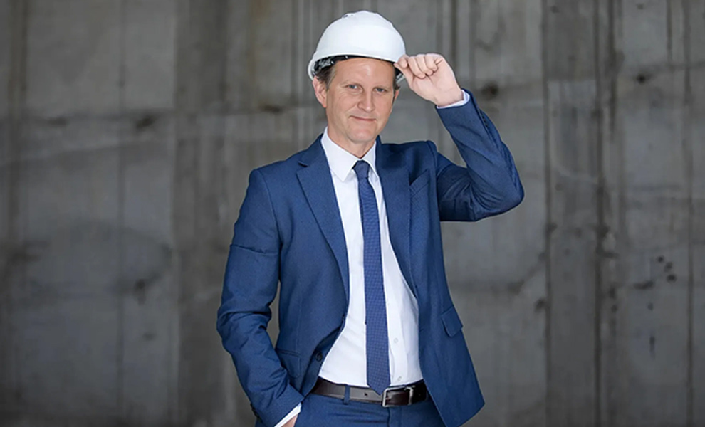Austin bad faith insurance attorney Dave Wenholz wearing a hard hat
