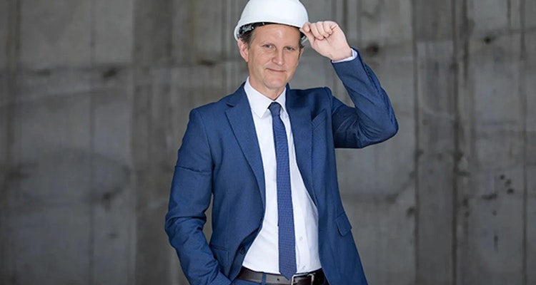 Austin bad faith insurance attorney Dave Wenholz wearing a hard hat