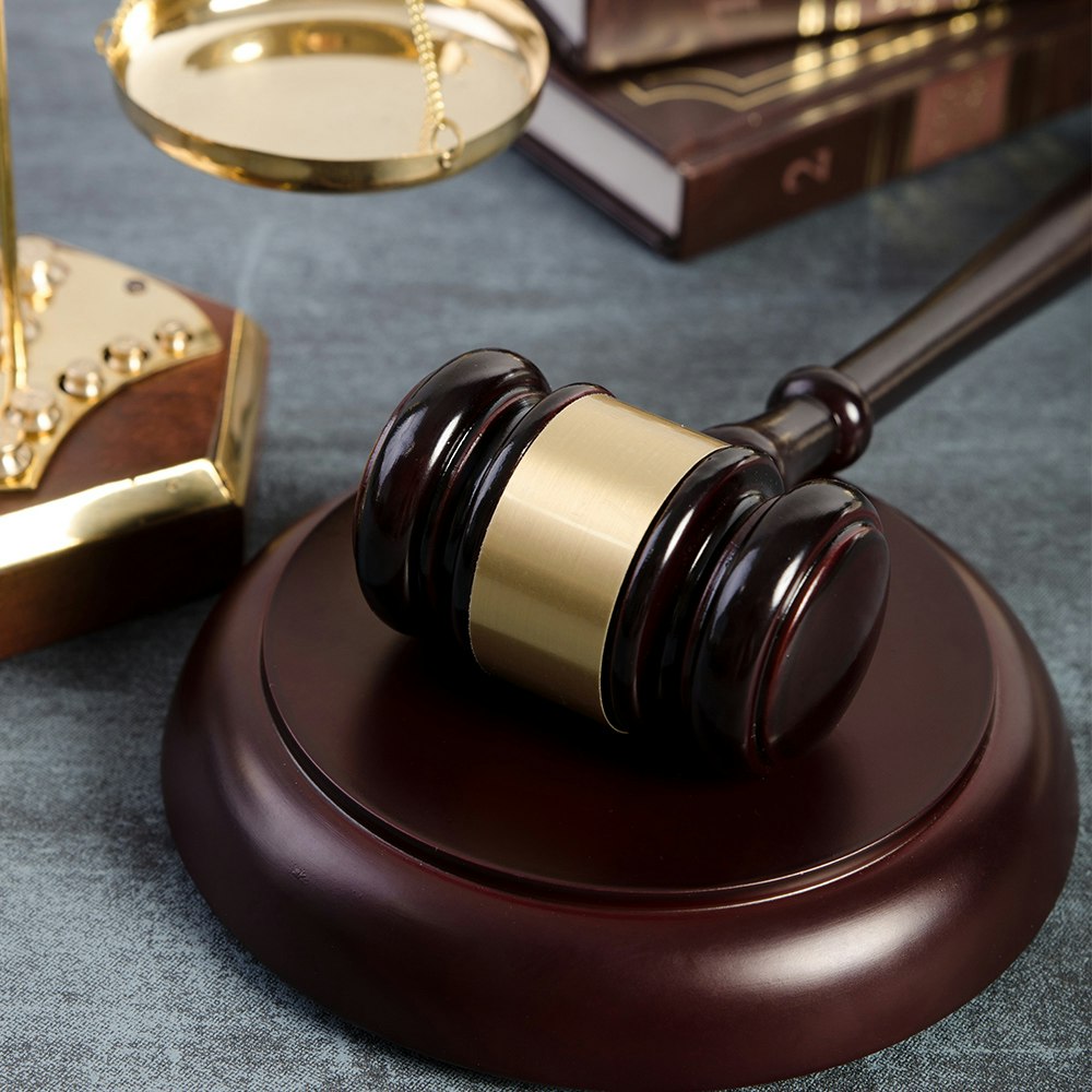 Gavel with scales of justice in background