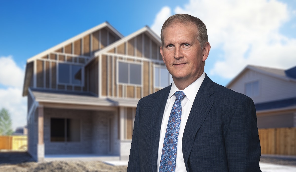 Construction defect attorney Dave Wenholz in front of home