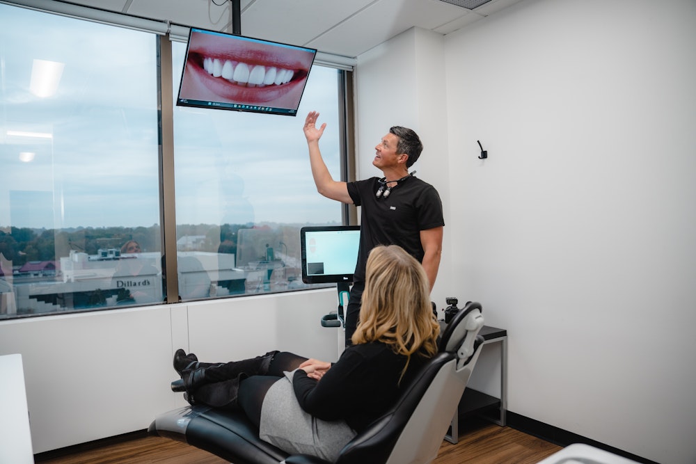 Dr. Hill showing smile scans to patient