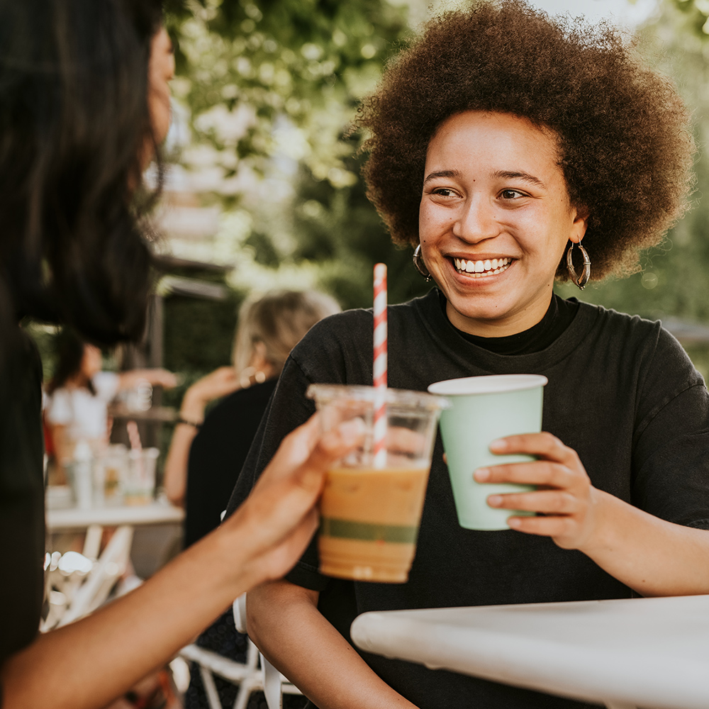 Woman drinking coffee with a friend