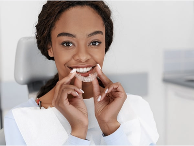 woman holding invisalign tray