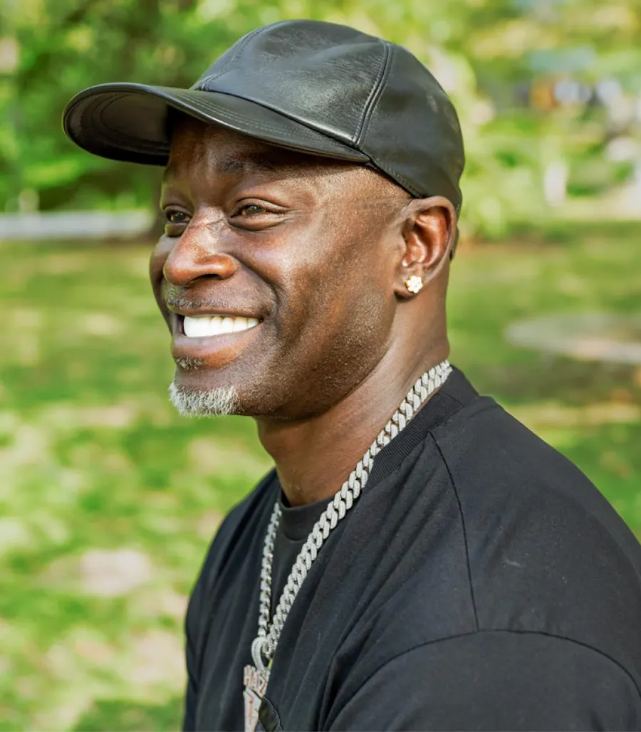 Actual patient of Dr. Scott Young smiling outdoors in a black cap