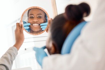 Woman admiring her new smile at the dentist