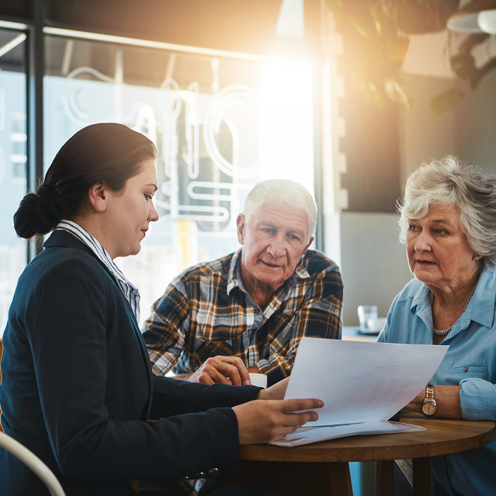 old couple reviewing documents with attorney
