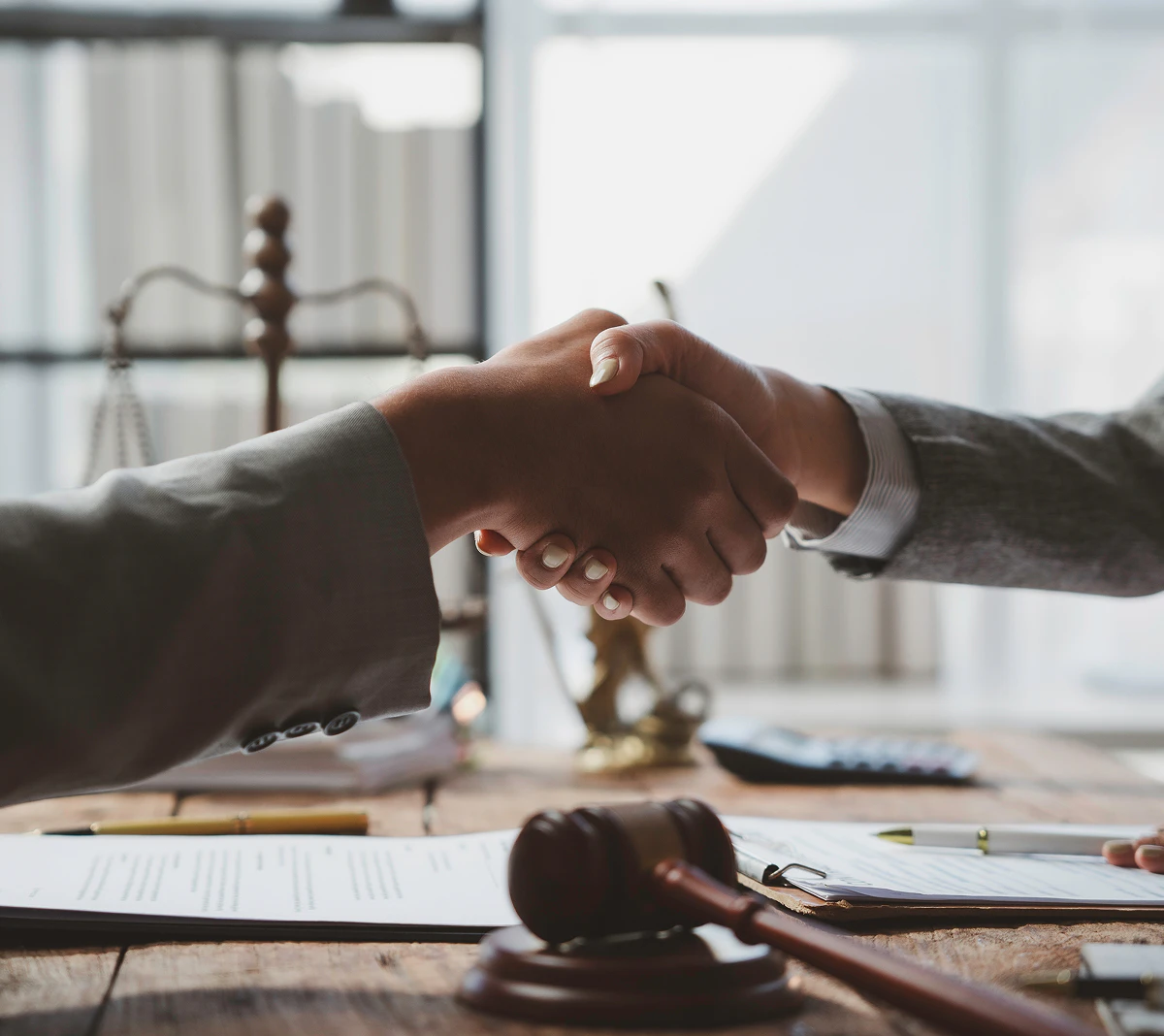 shaking hands over a desk
